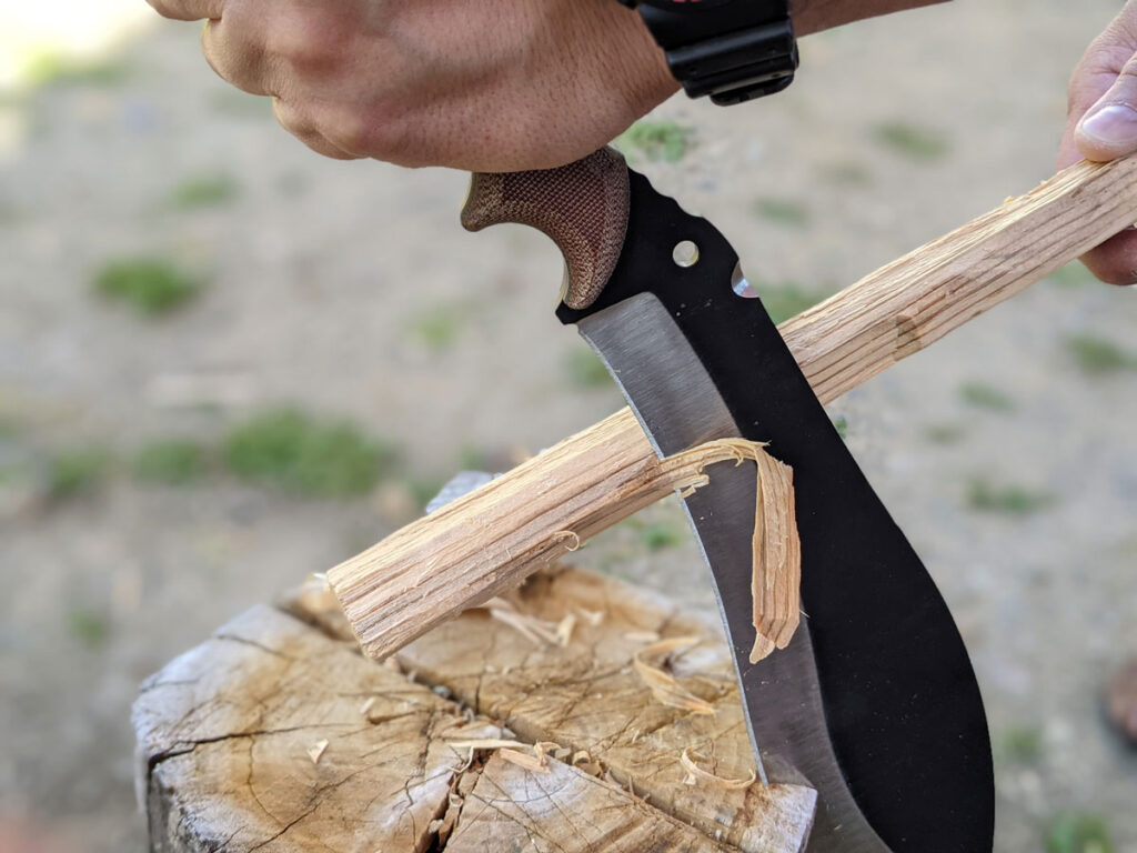 Jaime de la Parra using the SLYSTEEL Survival Kukri, a big survival knife, as a stationary draw knife. Photograph by Brandon Barlow.