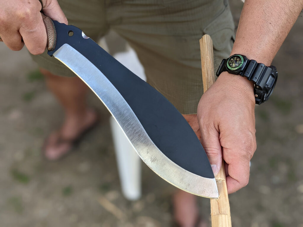 Jaime de la Parra holding the SLYSTEEL Survival Kukri by the handle, a big survival knife, to make a try stick knife tip mortice. Photograph by Brandon Barlow.