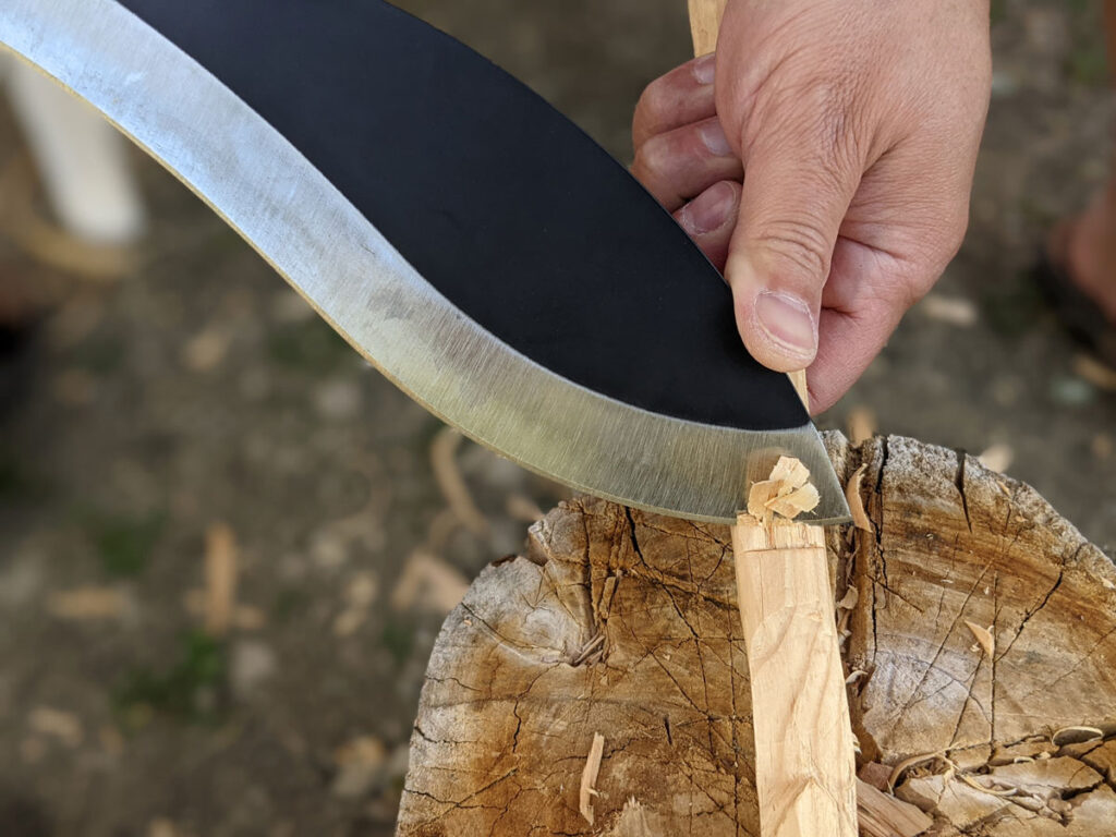 Jaime de la Parra using the SLYSTEEL Survival Kukri, a big survival knife, to make a try stick square notch. Photograph by Brandon Barlow.
