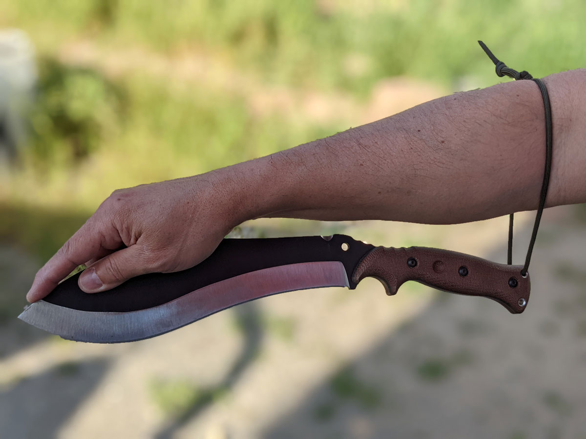 Jaime de la Parra holding the SLYSTEEL Survival Kukri knife at the tip using the lanyard hole and a loop. Photograph by Brandon Barlow.