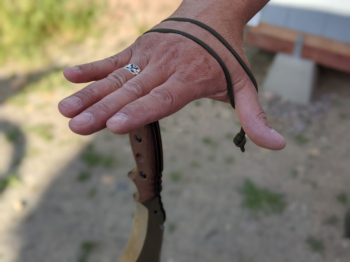 Jaime de la Parra dangling the SLYSTEEL Survival Kukri from the lanyard hole and a loop. Photograph by Brandon Barlow.