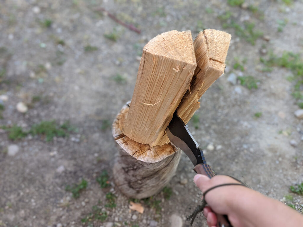 Jaime de la Parra splitting wood with the SLYSTEEL Survival Kukri with a lanyard hole and loop for additional grip retention. Photograph by Brandon Barlow.